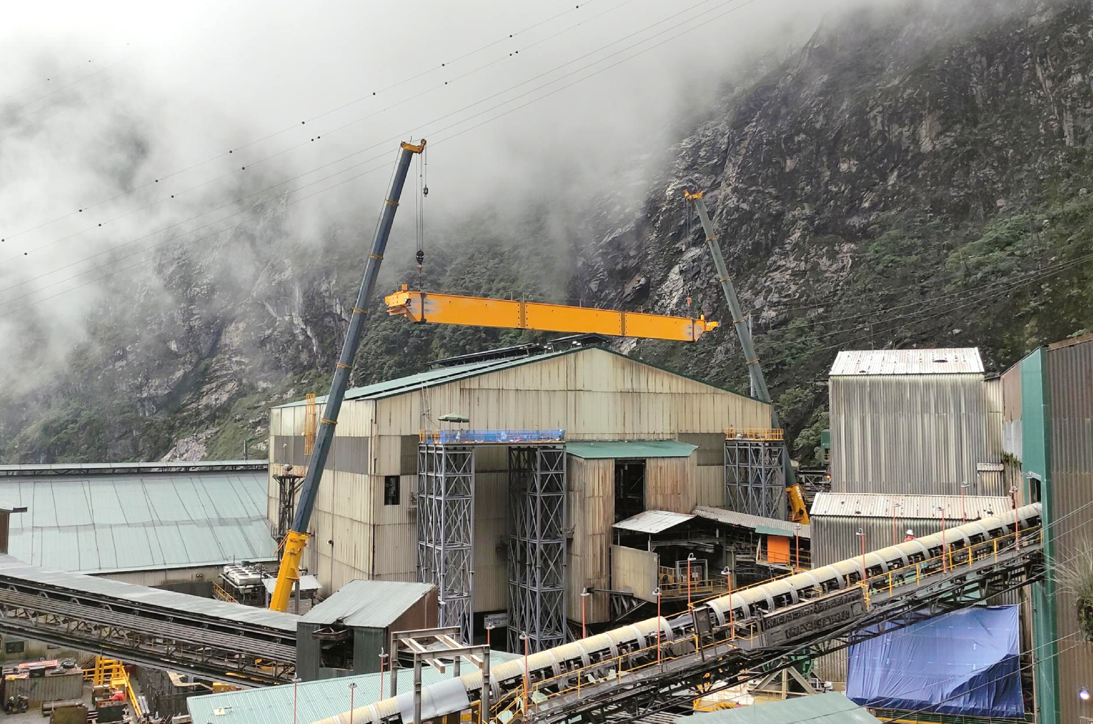 Old overhead crane removed in tight space using two 250t crawler cranes for lift-capacity upgrade.
